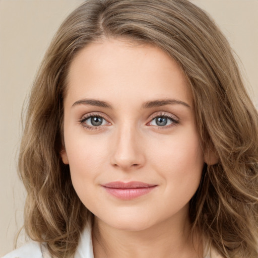 Joyful white young-adult female with medium  brown hair and green eyes