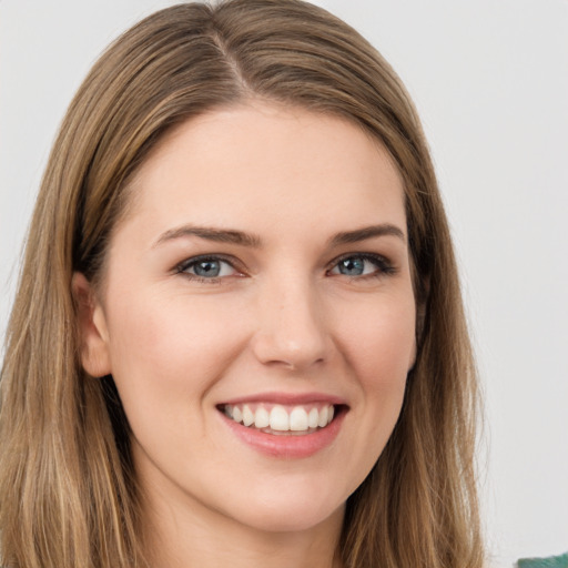 Joyful white young-adult female with long  brown hair and green eyes