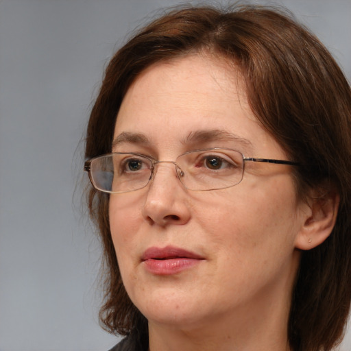 Joyful white adult female with medium  brown hair and grey eyes