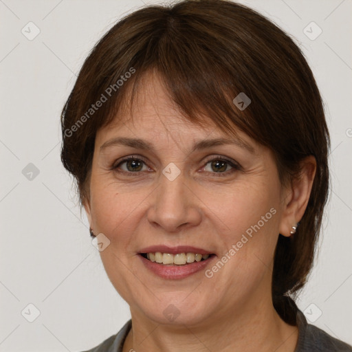 Joyful white adult female with medium  brown hair and grey eyes