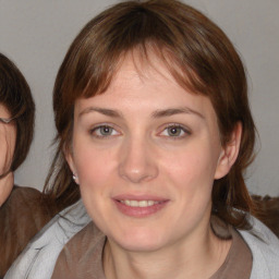 Joyful white young-adult female with medium  brown hair and blue eyes