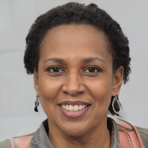 Joyful latino adult female with short  brown hair and brown eyes