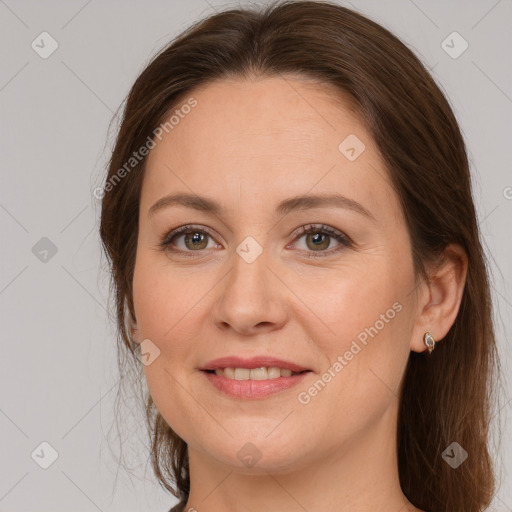 Joyful white adult female with long  brown hair and grey eyes