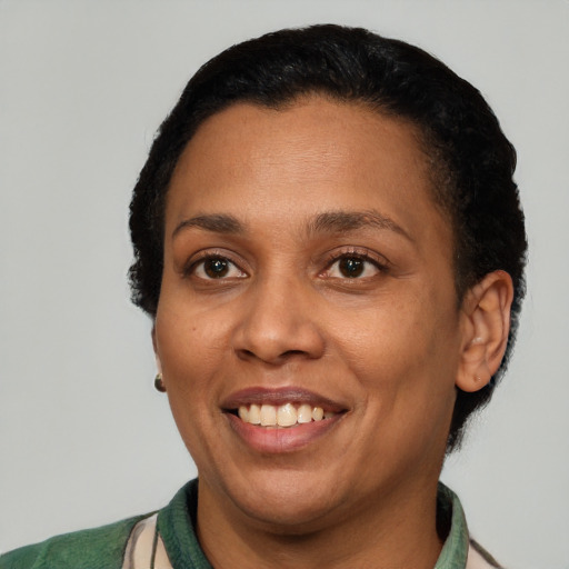 Joyful latino adult female with short  black hair and brown eyes