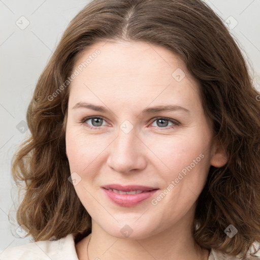 Joyful white young-adult female with medium  brown hair and green eyes