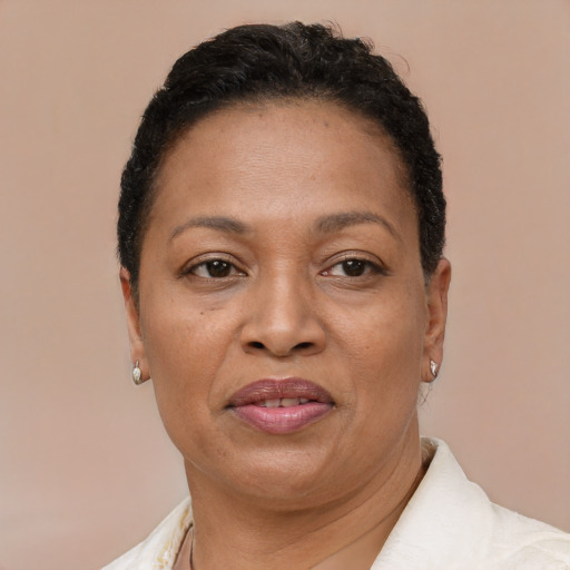 Joyful latino adult female with short  brown hair and brown eyes