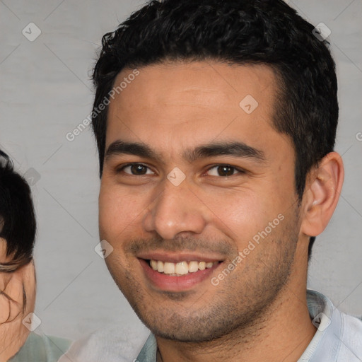 Joyful white young-adult male with short  black hair and brown eyes