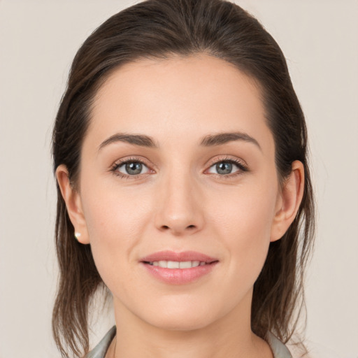 Joyful white young-adult female with medium  brown hair and brown eyes