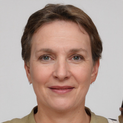 Joyful white adult female with short  brown hair and grey eyes