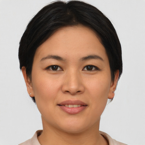 Joyful asian young-adult female with short  brown hair and brown eyes