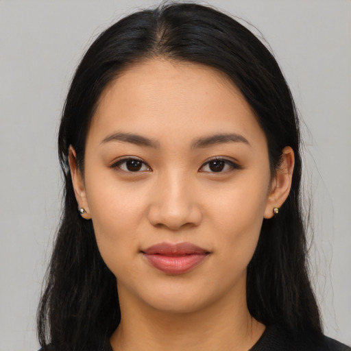 Joyful latino young-adult female with long  black hair and brown eyes