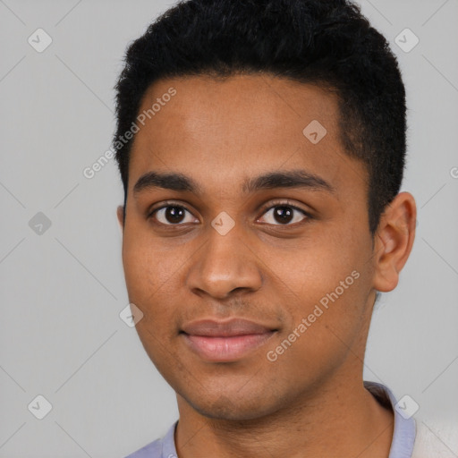 Joyful black young-adult male with short  black hair and brown eyes