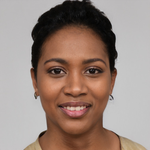 Joyful black young-adult female with short  black hair and brown eyes