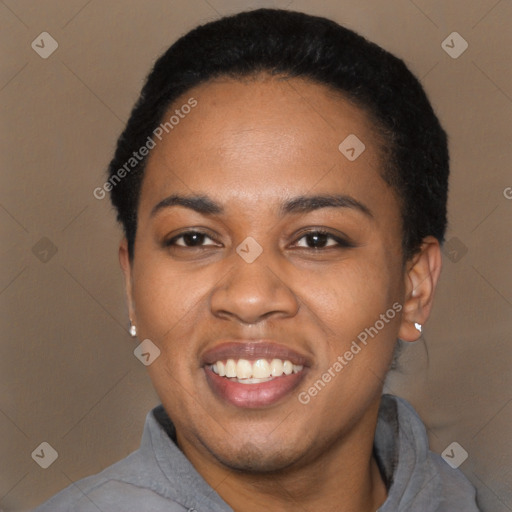 Joyful black young-adult female with short  black hair and brown eyes