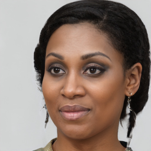 Joyful black young-adult female with medium  black hair and brown eyes