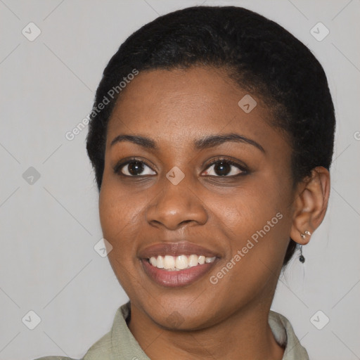 Joyful black young-adult female with short  black hair and brown eyes