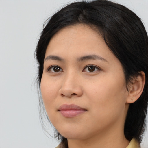 Joyful latino young-adult female with medium  black hair and brown eyes
