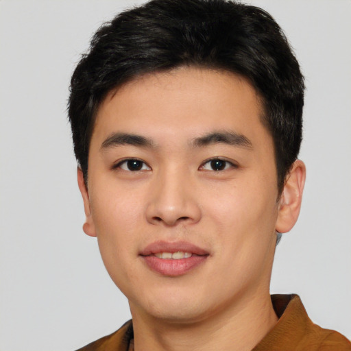 Joyful asian young-adult male with short  black hair and brown eyes
