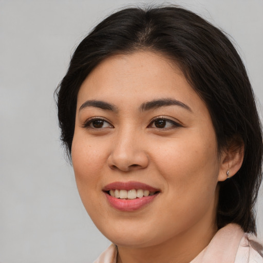 Joyful asian young-adult female with medium  brown hair and brown eyes