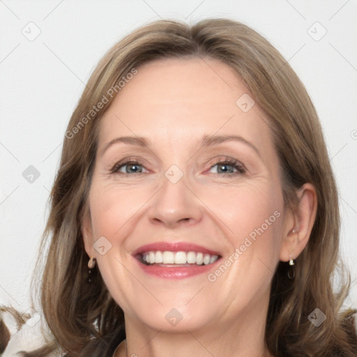 Joyful white adult female with long  brown hair and grey eyes