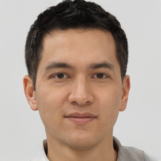 Joyful asian young-adult male with short  brown hair and brown eyes