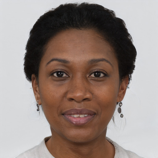 Joyful black adult female with short  brown hair and brown eyes