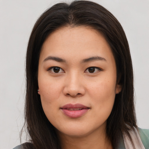 Joyful asian young-adult female with long  brown hair and brown eyes
