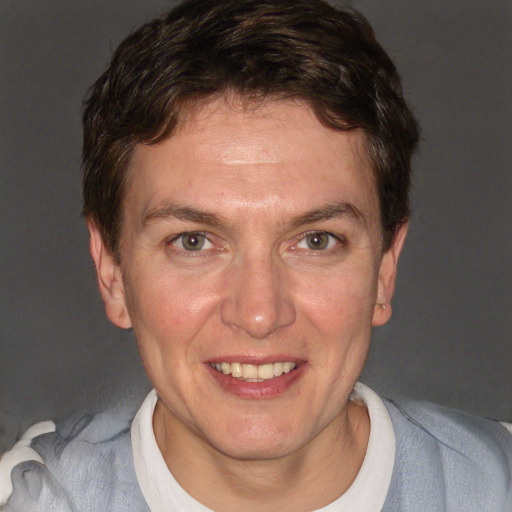 Joyful white adult male with short  brown hair and blue eyes