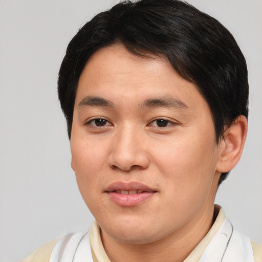 Joyful asian young-adult male with short  brown hair and brown eyes