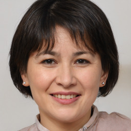 Joyful white adult female with medium  brown hair and brown eyes