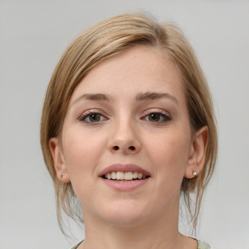 Joyful white young-adult female with medium  brown hair and grey eyes