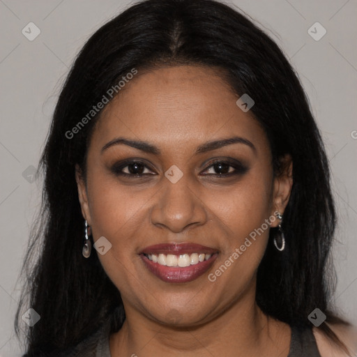 Joyful black young-adult female with long  brown hair and brown eyes