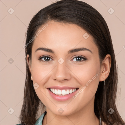 Joyful white young-adult female with long  brown hair and brown eyes