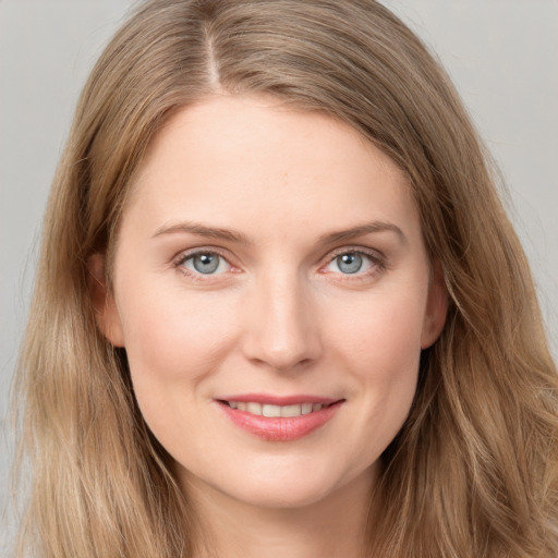 Joyful white young-adult female with long  brown hair and grey eyes