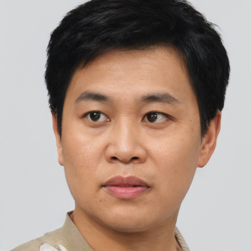 Neutral asian adult male with short  black hair and brown eyes