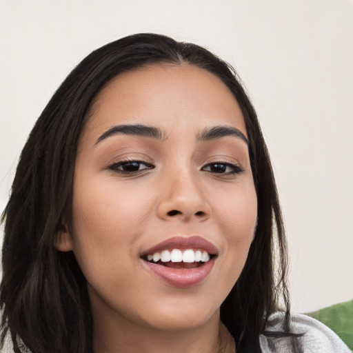 Joyful white young-adult female with long  black hair and brown eyes