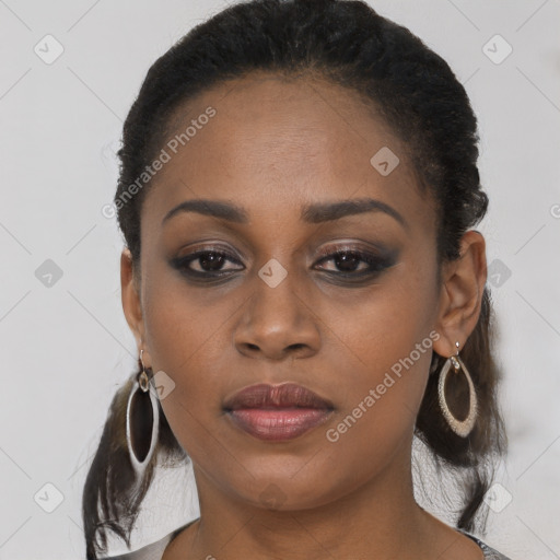 Joyful black young-adult female with long  brown hair and brown eyes