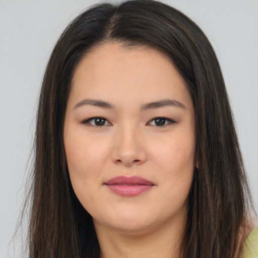 Joyful asian young-adult female with long  brown hair and brown eyes