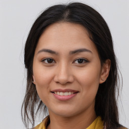 Joyful asian young-adult female with long  brown hair and brown eyes