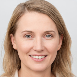 Joyful white young-adult female with medium  brown hair and blue eyes