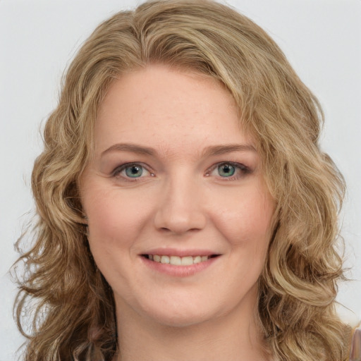 Joyful white young-adult female with long  brown hair and green eyes