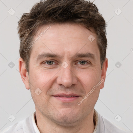 Joyful white adult male with short  brown hair and brown eyes