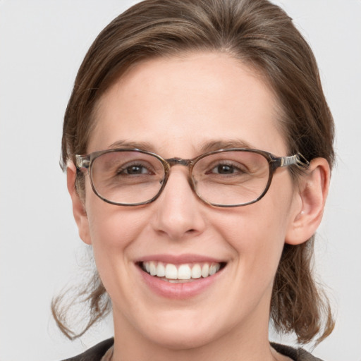 Joyful white adult female with medium  brown hair and grey eyes