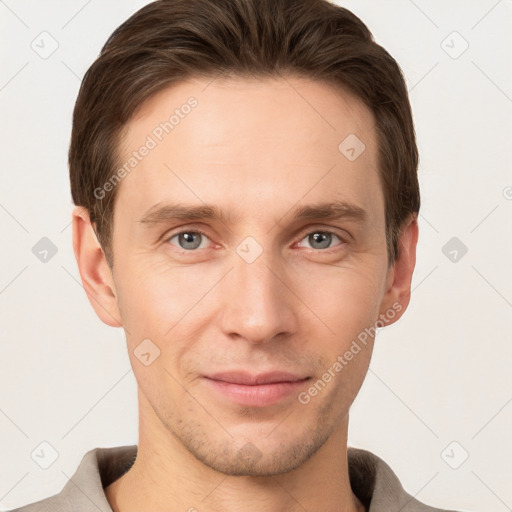 Joyful white young-adult male with short  brown hair and grey eyes