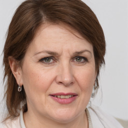 Joyful white adult female with medium  brown hair and grey eyes