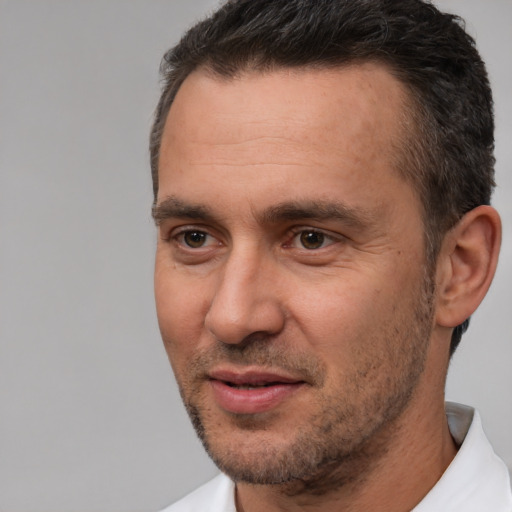 Joyful white adult male with short  brown hair and brown eyes