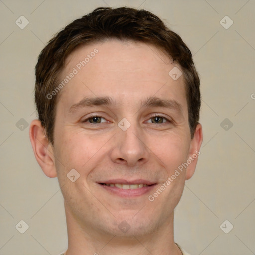 Joyful white adult male with short  brown hair and grey eyes