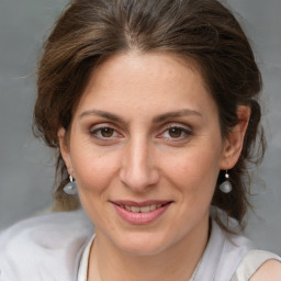 Joyful white adult female with medium  brown hair and brown eyes