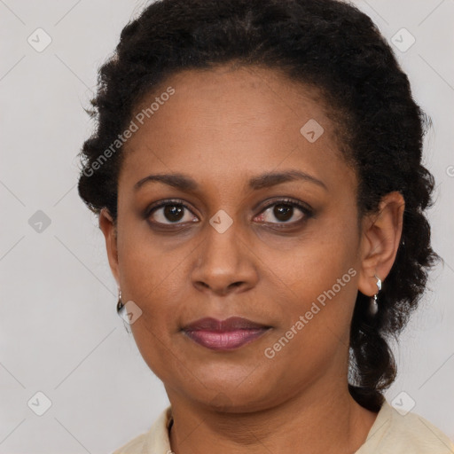 Joyful black adult female with short  brown hair and brown eyes