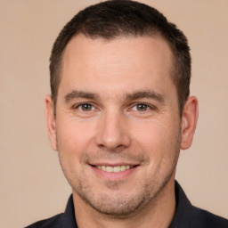 Joyful white adult male with short  brown hair and brown eyes